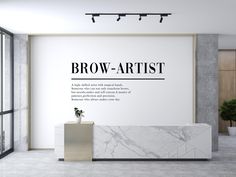 a white marble counter in front of a wall with the words brow - artist on it