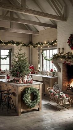 a rustic kitchen decorated for christmas with wreaths and garland on the windows, an old fireplace in the background