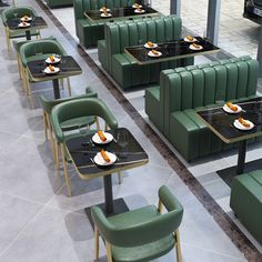 tables and chairs are lined up with plates on them