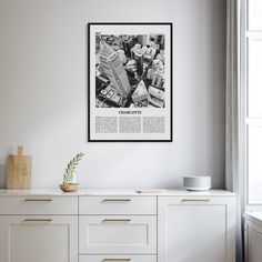 a black and white photo hanging on the side of a wall next to a dresser