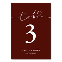 a table number card with the numbers 3 and 3 in white ink on maroon paper