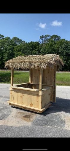 a small wooden stand with a straw roof