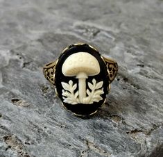 a black and white ring with an image of a mushroom on it's side