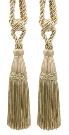 two rope tassels are hanging from the end of each other on a white background