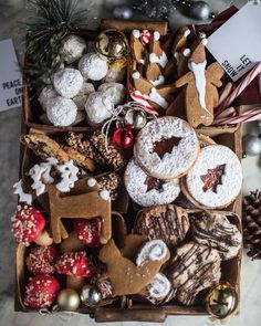 a box filled with lots of different types of cookies and other holiday treats on top of a table