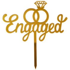 an engagement cake topper with the word engaged on it and a diamond in the middle