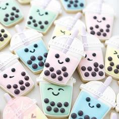 decorated cookies in the shape of drinks and ice creams are arranged on a table