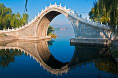 an arched bridge over a body of water