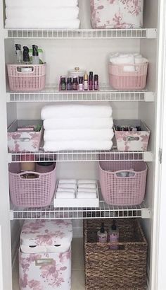 an organized closet with baskets, towels and toiletries on shelves next to each other