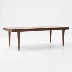 a wooden table sitting on top of a white floor