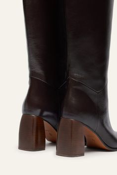 - High shaft- Slip-on style- Pointed toes- Cuban heel covered in leather- Material: lamb or cow leather- Leather lining- Leather sole- Heel height: 8 cm- Shaft height: 46 cm- Made in Spain Western Leather Knee-high Boots With Block Heel, Brown Wide Calf Mid-calf Boots With Stacked Heel, Brown High Heel Mid-calf Boots With Reinforced Heel, Luxury Brown Ankle-high Moto Boots, Brown Ankle-high Moto Boots With Zipper Closure, Cuban Heels, Short T Shirt, Boot Bag, Scarf Jewelry