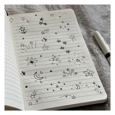 an open notebook with stars and moon drawings on it