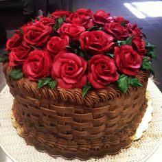 a chocolate cake with red roses on top