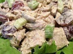 a salad with lettuce, grapes and chicken in it