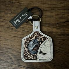 a leather keychain with an image of a fish on it