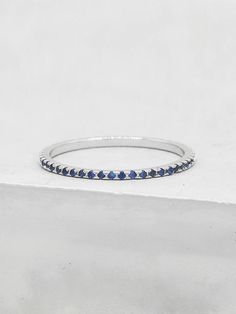 a white gold ring with blue sapphire stones