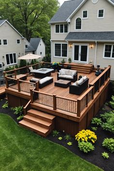 a backyard deck with furniture and landscaping in the background