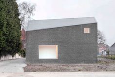 the house is made out of bricks and has two windows on each side of it