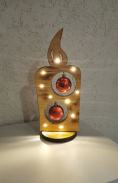 a wooden light up traffic signal with lights on it's sides and an ornament in the middle