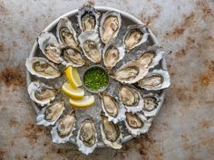 an oyster platter with lemon wedges and parsley