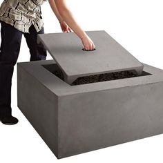 a person placing something into a concrete box