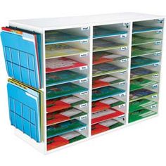 a white shelf with many files and folders on it