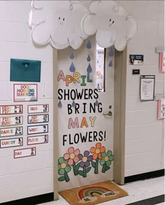 a classroom door decorated with flowers and clouds