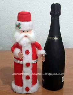 a wine bottle with a santa claus figure next to it