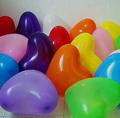 there are many different colored balloons on the floor