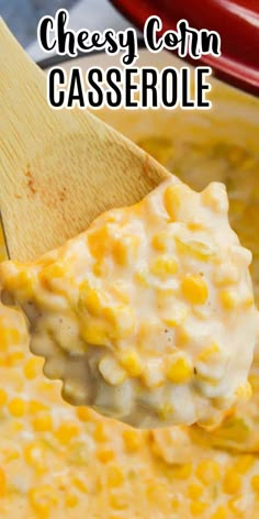 a spoon full of cheesy corn casserole with a wooden spoon in it