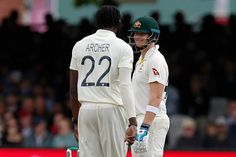 two cricket players standing next to each other