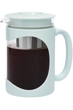 a white coffee pot with a glass lid and handle on it's side, filled with liquid