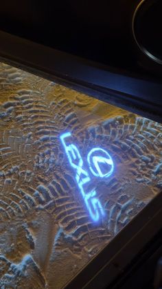 a lit up sign that is on top of a table