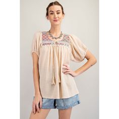 Cotton Gauze Ethnic Patch Detailing Top -Rounded Neckline With A Tie Closure -Relaxed And Loose Fit Silhouette -Short Puff Sleeves -Pleated Throughout Beige Bohemian Peasant Top For Beach, Bohemian Blouse With Woven Motifs For Festivals, Beige Bohemian Blouse With Boho Print, Bohemian Blouse With Woven Motifs, Bohemian Tops With Woven Motifs For Spring, Folk Style Peasant Top For Beach, Beige Bohemian Peasant Top For Vacation, Bohemian Tops With Geometric Embroidery, Bohemian Peasant Top With Geometric Embroidery For Spring