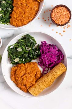 two white bowls filled with different types of food on top of a table next to each other