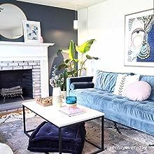 a living room filled with furniture and a fire place in front of a white fireplace