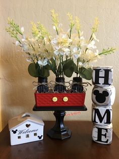 a table topped with blocks and flowers on top of it