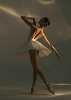 a ballerina in white tutu and ballet shoes