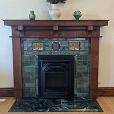 a fire place with a vase on top of it