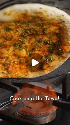 a pizza cooking on top of an outdoor grill with the words cook on a hot tawa