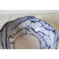 a blue and white bowl sitting on top of a table