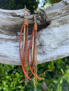 Brown and burnt orange colored suede with chain. description: these beautiful earrings have a distinctive design that uses length for movement and added dimension. hand crafted from colored suede and leather strips and beautiful thrifted necklace and bracelet chains, allow for a beautiful and fun up cycling. they come in different lengths ranging for 3" to 5" so there is a perfect fit for everyone. our goal is to create a unique piece of art that can cater to every style and add a little flare to everyday wear. Brown Jewelry With Adjustable Chain For Festival, Brown Tassel Jewelry For Festivals, Brown Multi-strand Jewelry With Dangling Beads, Leather Dangle Jewelry For Party, Brown Dangle Jewelry For Festivals, Orange Fringe Jewelry For Festivals, Brown Fringe Jewelry For Festivals, Brown Dangle Jewelry For Festival, Party Leather Dangle Jewelry