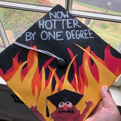 a graduation cap with the words now potter by one degree on it and an image of a fire monster