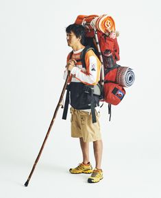 a man with a backpack and skis on his back is standing in front of a white background