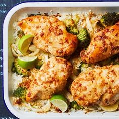 chicken, broccoli and rice in a casserole dish with lime wedges