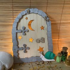 an image of a wooden door with stars and moon decorations on the front, along with other items