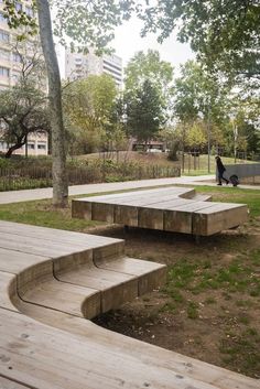 an empty park with wooden steps and benches