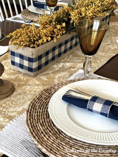 the table is set with blue and white place mats, napkins, and silverware