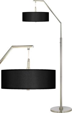 two lamps with black shades on them and one light is turned on the other side