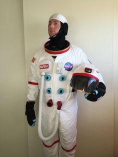 a man in an astronaut suit holding a vacuum